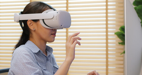 Metaverse app STEM platform developer future skill job workforce for asia people young woman work at home office wear VR headset typing test game on AI IT cyber security cloud computing web solution.