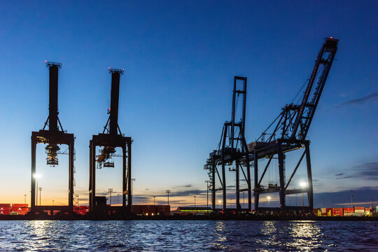 Gantry granes silhouetted against sunrise in the Port of Wilmington along the Cape Fear River, North Carolina
