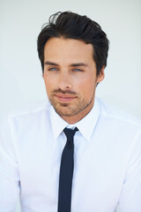 Face, smile or vision and a thinking business man on a white background with a professional mindset. Idea, future and planning with a confident young employee looking thoughtful about his career