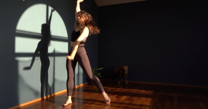 Curly girl dances contemporary in the studio 
