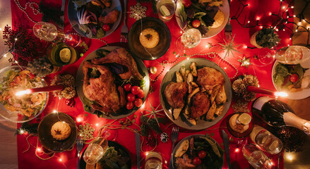 Top view no people shot of holiday Christmas table with variety of food and cozy atmosphere 