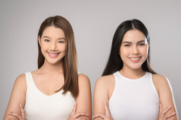 Two beautiful woman in white shirt over white background studio, skin care and beauty concept