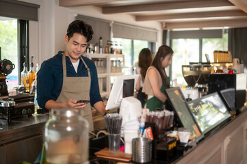 Young Asian service minded barista  with customer in coffee shop