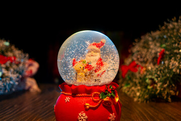 Santa Claus toy Christmas. A ball with the snow. New Year's card blank. Merry Christmas background for design, decoration and advertising. Christmas Snow Ball.