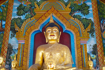 Fototapeta premium Beautiful Wat Buddhist temples in Chiangmai Chiang mai Thailand. Decorated in beautiful ornate colours of red and Gold and Blue. Lovely sunset