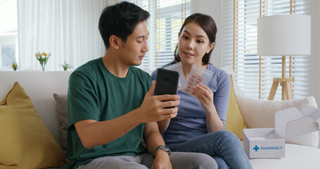 Young married asia people prepare pregnant plan checkup preconception consult at home sofa. Clinic...