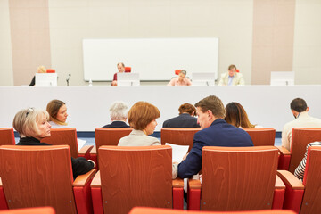 Audience sitting in front of panel at conference event