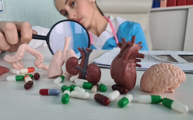 Doctor magnifies person internal organs using magnifying glass