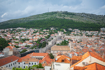 Fototapeta na wymiar View to the red roofs of Dubrovnik Old town on cloudy summer day. 