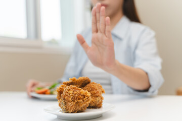 Diet food loss weight concept, Hand of woman pushing fast food away and avoid to eat fried chicken...