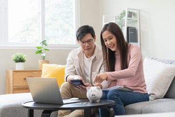 financial in family concept, Happy Asian husband and wife calculating income and bills to plan for...