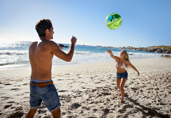 Couple, ball playing and fun by beach in summer with love, care and support together on a holiday....