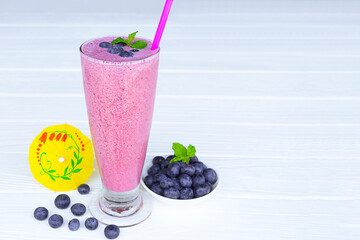 Blueberry Juice smoothies drink in a glass drink purple colorful fruit juice milkshake blend beverage healthy high protein the taste yummy in glass on white wood background.