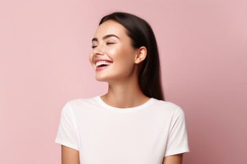 Fototapeta premium A laughing woman on a studio pastel background.