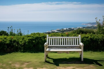Serene Seaside Escape White Bench on Lush Green Grass Overlooking the Ocean Generative AI