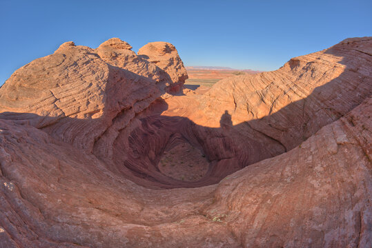 Silhouette of a person on Shiva Nandi Rock, Beehive Trail, New Wave, Glen Canyon National Recreation Area near Page, Arizona, USA