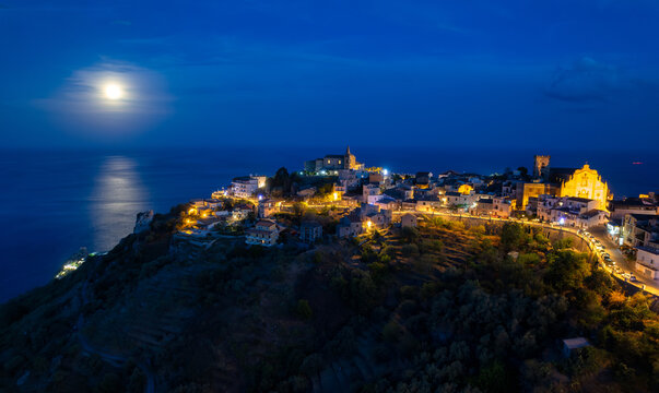 Full moon over Forza d'Agro and coastline, Messina, Sicily, Italy