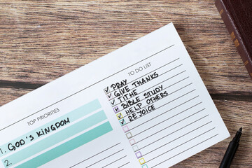 Handwritten Christian priorities (God's kingdom) and to-do list in notebook. Biblical concepts of...