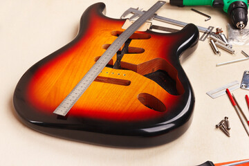 Electric guitar body at workplace of guitar master.
