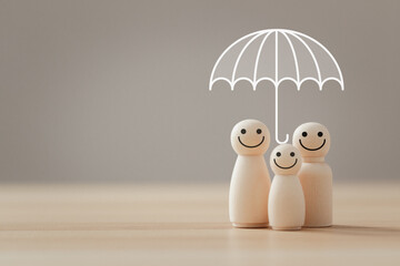 Family insurance and safety concept, Wooden figure with umbrella icon for protecting and care...