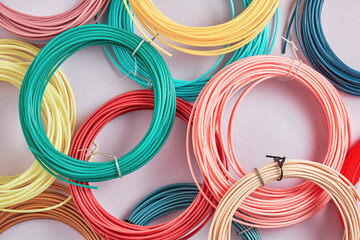 Above view of bunch of colorful plastic strings for modern 3D pen. Hobby, toys and craft textures and backgrounds