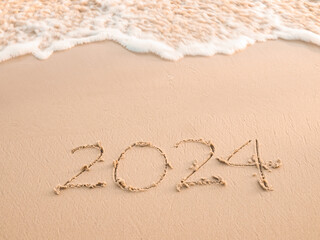 2024 year written on the beach in the sunset time. New Year 2024 concept