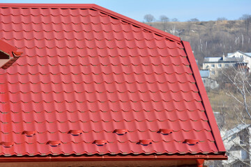 Naklejka premium The roof of the house is covered with metal tiles