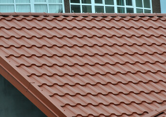 Naklejka premium The roof of the house is covered with metal tiles