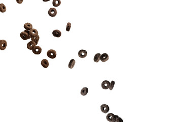 Chocolate rings cereal spill out into a bowl. Breakfast.