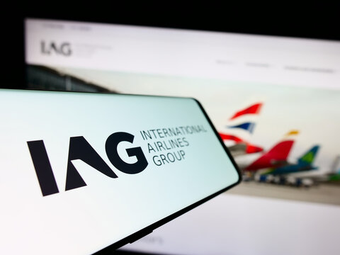 Stuttgart, Germany - 11-17-2023: Smartphone with logo of International Consolidated Airlines Group SA (IAG) in front of business website. Focus on center-left of phone display.