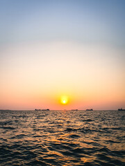 Cargo ships on the Aegean Sea during sunset with clear sky