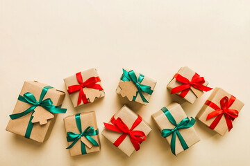 Colored craft gift boxes with colorful ribbons on colored background. Collection of Christmas present boxes