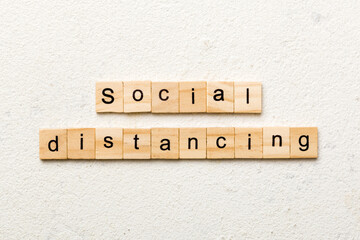 social distancing word written on wood block. social distancing text on cement table for your desing, concept