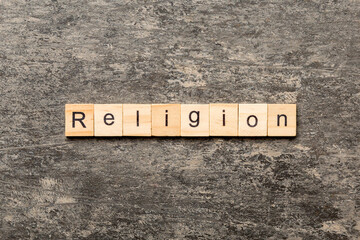 Religion word written on wood block. Religion text on cement table for your desing, concept