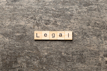 legal word written on wood block. legal text on table, concept