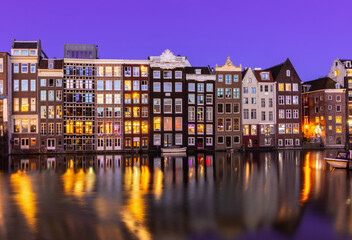 Amsterdam architecture on Damrak canal at night, Netherlands