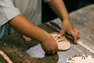 Baby's hand playing with bread dough and making shapes.