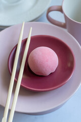 Pink mochi dessert with cream filling and berry