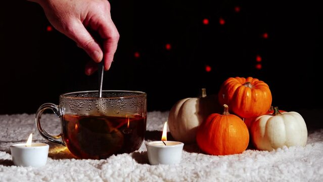 Hot drink of tea in autumn pumpkin scene