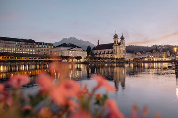Fototapeta premium The Chapel bridge and the Jesuit Church of Lucern with Mount Pilatus in the background, Central Switzerland, tourism in Europe