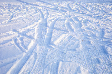 Winter snowy ground with tire mark. Way covered in lot of snow white tire print as background.