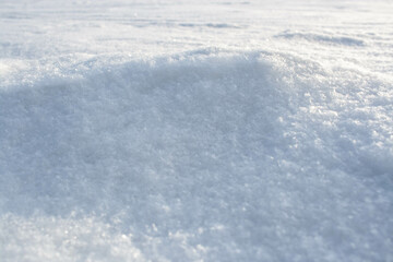 Obraz premium Natural snow texture of snowdrift. Winter backdrop with snowy ground. Patterns on snow surface.