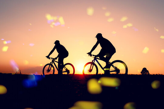 colorful of cyclist and Bicycle silhouettes on the dark background of sunsets