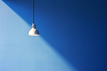 A lamp hangs on a blue wall  and illuminates it, space for text or presentation. Generative Ai