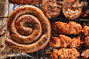 grilled sausages on the grill. South African braai with boerewors and lamb chops 