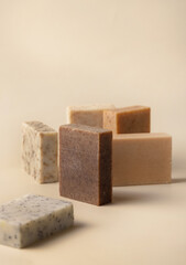 Natural herbal beige and brown soap bars on light beige close up