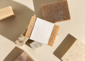 Beige and brown soap bars on light beige top view, hard shadows, packaging mockup