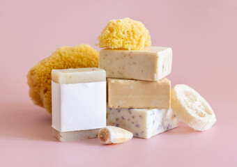 Soap bars with blank label, natural sponge and seashell on pink close up, mockup