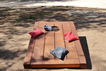 Cornhole game with blue and red bags