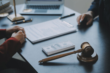 Justice and law concept.Male judge in a courtroom with the gavel, working with, computer and...